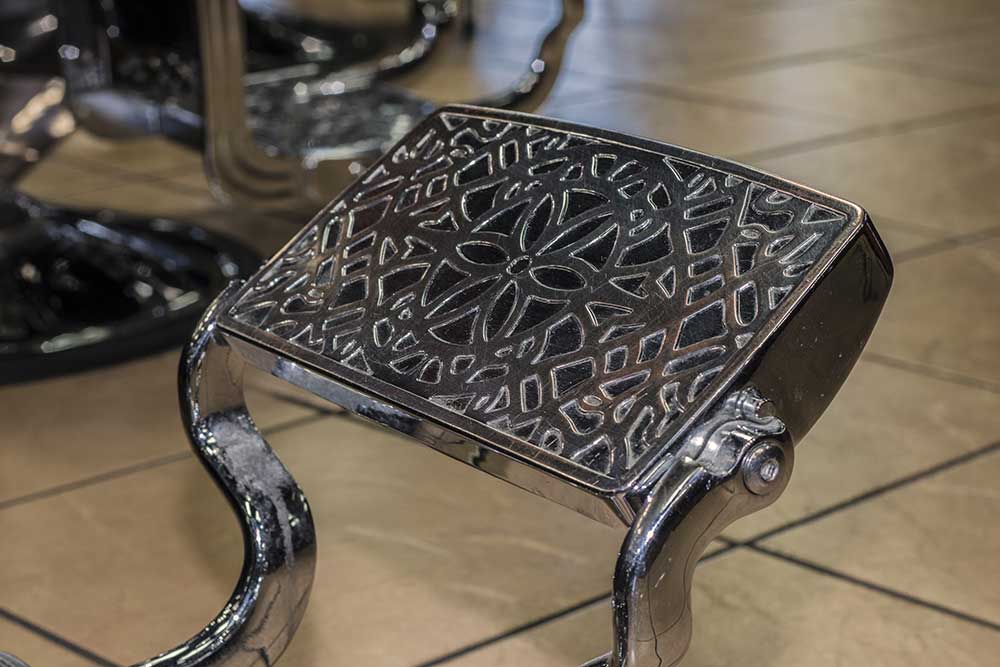 view of barber chairs foot rest